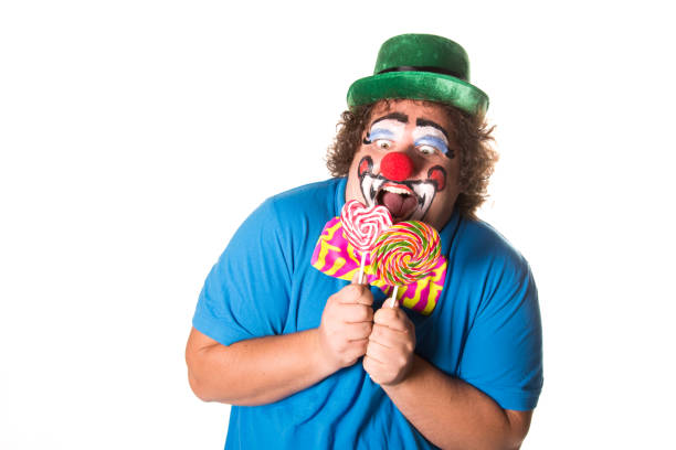 istock Funny clown. Fat man with candy. 1071819990