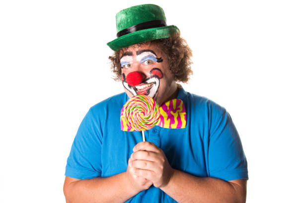 istock Funny clown. Fat man with candy. 1071820072