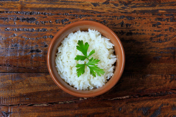 istock white rice inside ceramic pot on wooden table, top view 1071821510