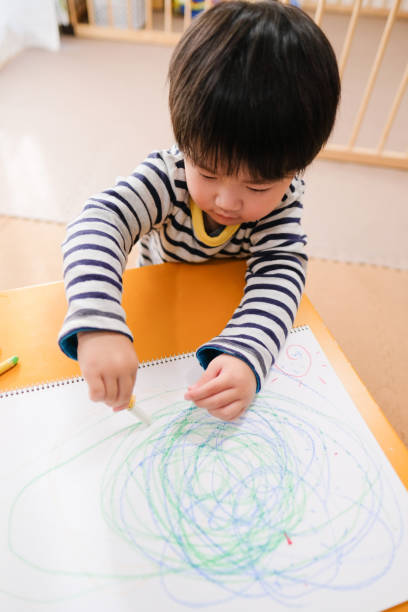 istock Toddler drawing picture on table 1071821636