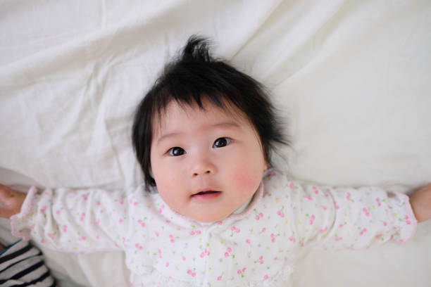 istock Closeup of baby lying on bed 1071821810