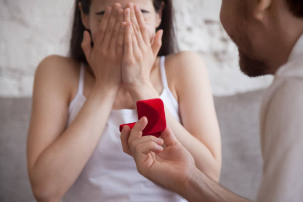 istock Man holding red box, preparation make proposal to woman 1071821918
