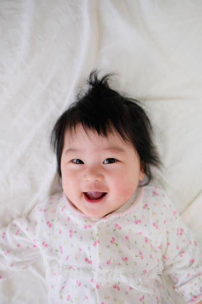 istock Closeup of baby lying on bed 1071821962