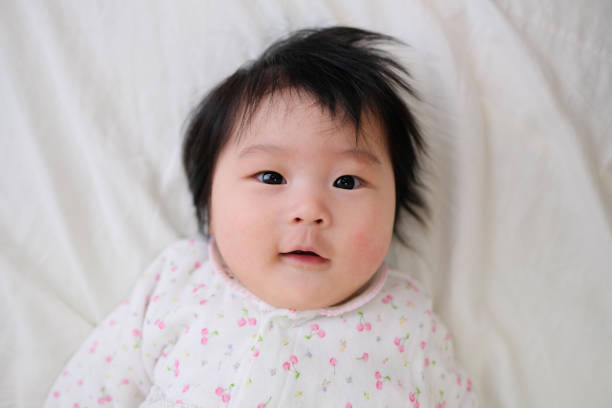 istock Closeup of baby lying on bed 1071821992