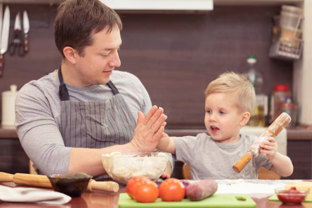 istock Dad and son cooking pizza at home 1071823986