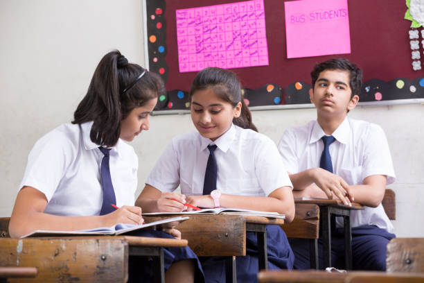 istock Female student in classroom - Stock image 1071824316