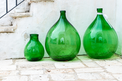 Green glass amphora on the outside of a farmhouse in Puglia, in southern Italy.