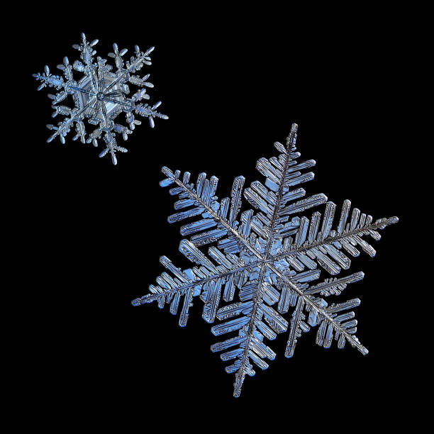 istock Two snowflakes isolated on black background 1071826848