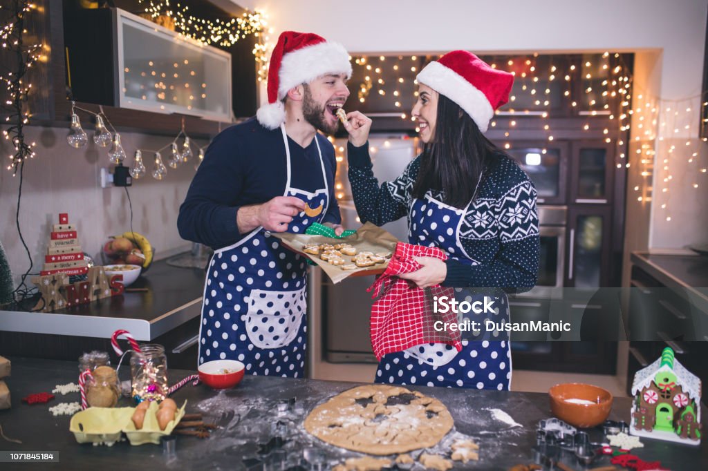 Happy Couple Baking Christmas Cookies Stock Photo - Download Image Now - Adult, Bakery, Baking - iStock