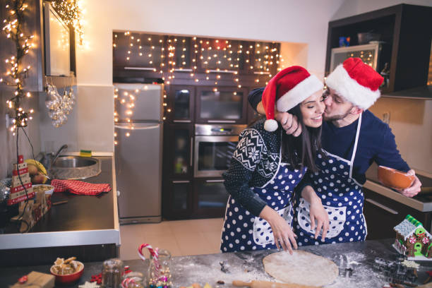 Happy couple baking Christmas cookies stock photo