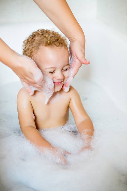 istock Cute two year old boy taking a relaxing bath with foam 1071877278