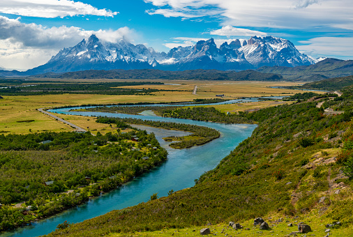 Landscape photograph of the Torres and Cuernos of the Paine Massif and Serrano river inside Torres del Paine national park, Patagonia, Chile.