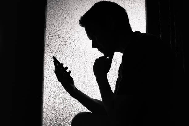 istock Young man reading on smartphone at home. 1071896326