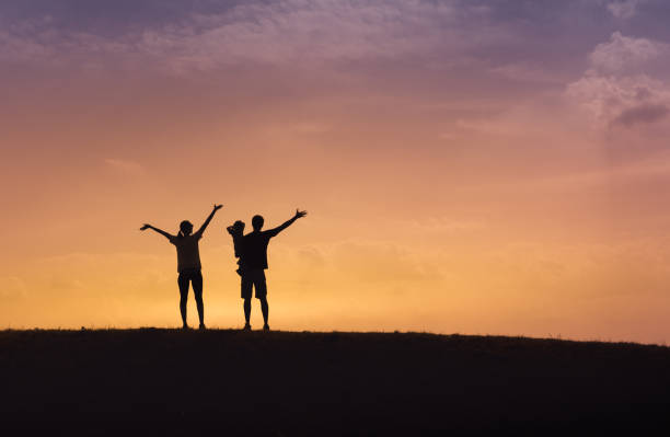 istock Happy family enjoying beautiful sunset. 1071896354