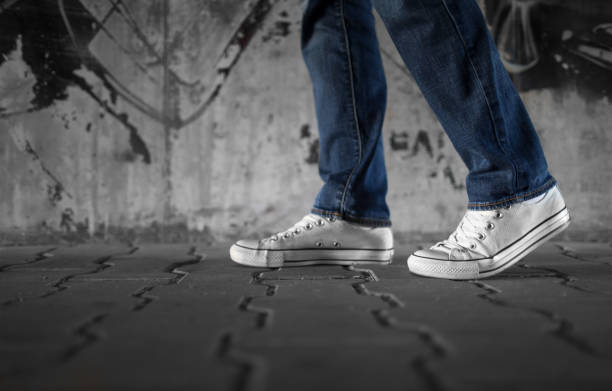 Closeup of person's feet walking city street