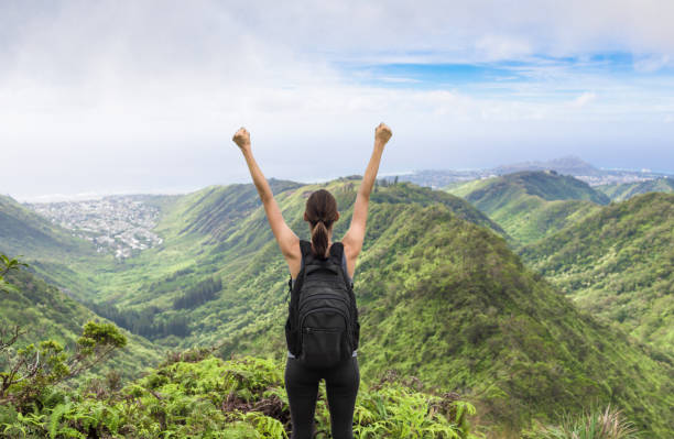 Yes, I did it! Female hiker enjoying the beautiful mountain view. (location Hawaii) record breaking stock pictures, royalty-free photos & images