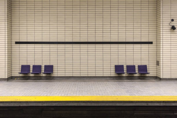 Two sets of purple chairs attached to tiled wall Two sets of purple chairs attached to tiled wall in underground subway montreal underground city stock pictures, royalty-free photos & images
