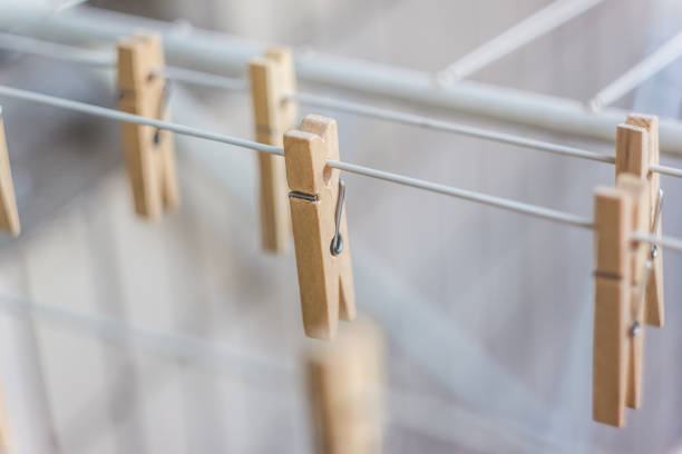 Wooden clothespins on a clothesline, blur, light photo. The concept of eco-consumption, the use of natural materials, awareness Wooden clothespins on a clothesline, blur, light photo. The concept of eco-consumption, the use of natural materials, awareness. clothespin wood stock pictures, royalty-free photos & images