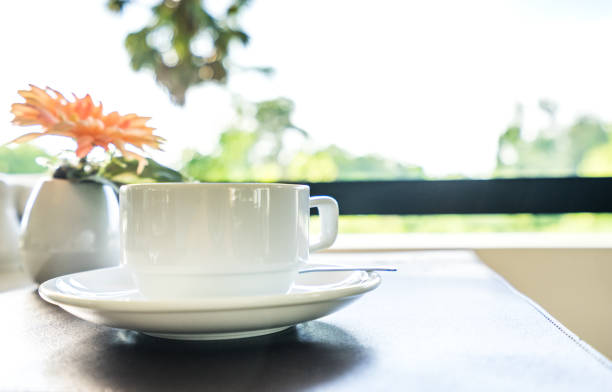 istock white coffee cup on table in morning background - can use to display or montage on product 1071915496