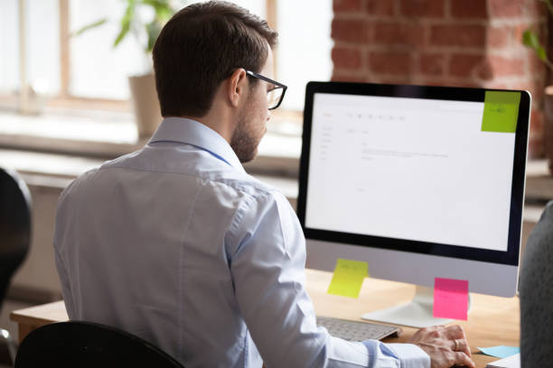 istock Serious male employee write business letter to client 1071915500
