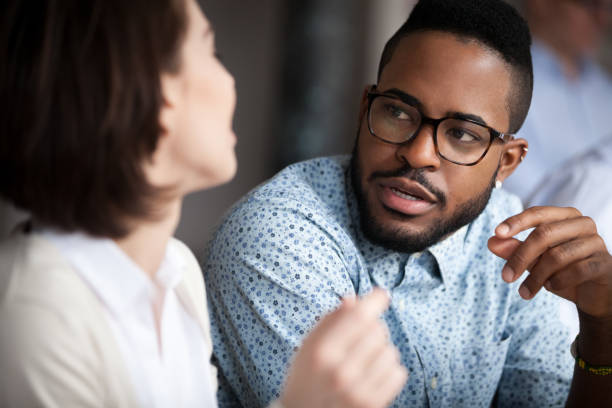 istock Multiracial colleagues talk discussing projects in office 1071915504