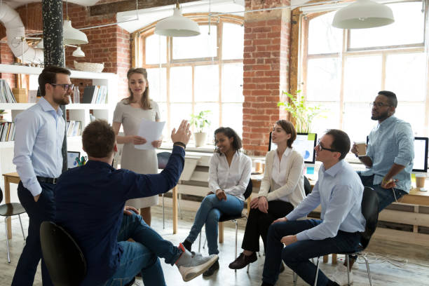 istock Male worker raise hand asking question at office teambuilding 1071915646