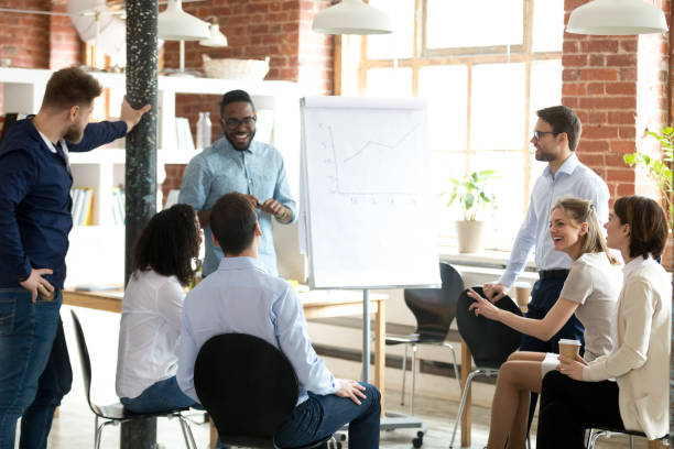 istock Excited black coach make flipchart presentation for employees 1071915654