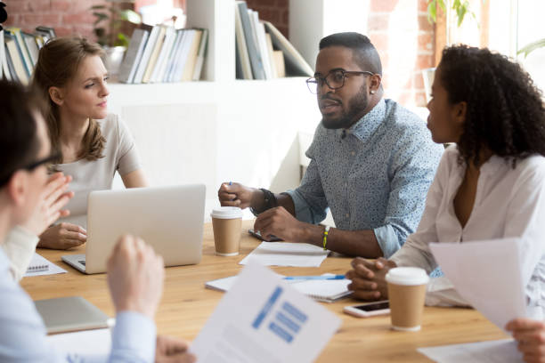 istock Diverse colleagues negotiate at business meeting expressing thoughts 1071915664