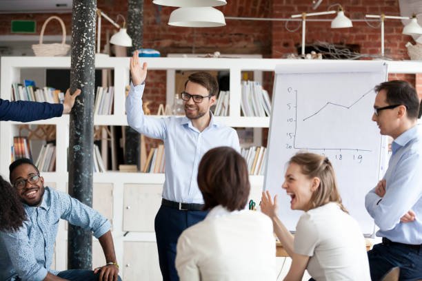 istock Diverse colleagues laughing engaged in teambuilding activity at meeting 1071915696