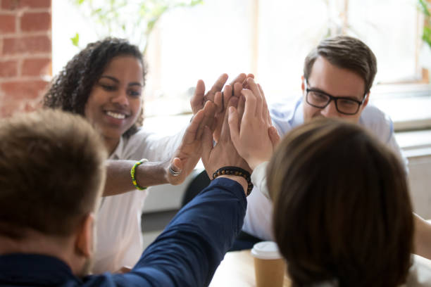 istock Diverse employees give high five during company office briefing 1071915704