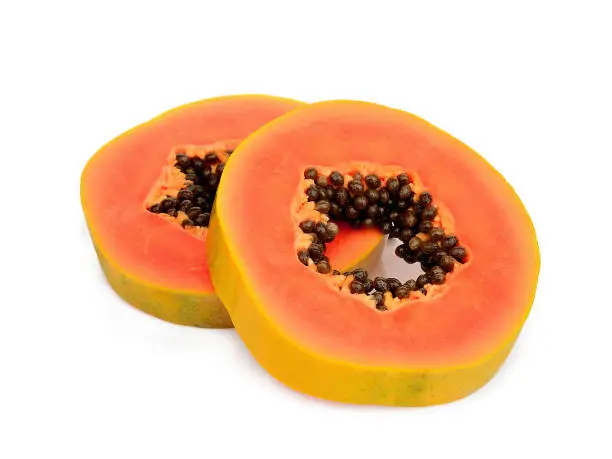 two sliced ripe papaya with seeds isolated on white background