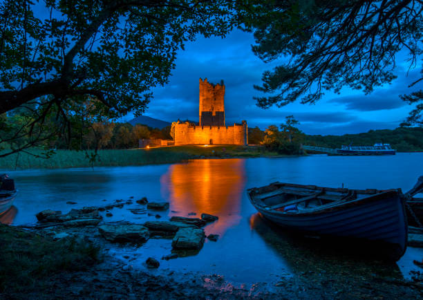 Ross Castle in Killarney National Park Killarney, Republic of Ireland - August 16th 2018: A dusk-time view of the magnificent Ross Castle, located on the edge of Lough Leane in Killarney National Park, Republic of Ireland. killarney lake stock pictures, royalty-free photos & images