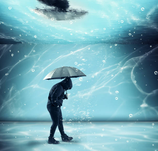 istock Man hold an umbrella and walks underwater , in a pool. 1071943792