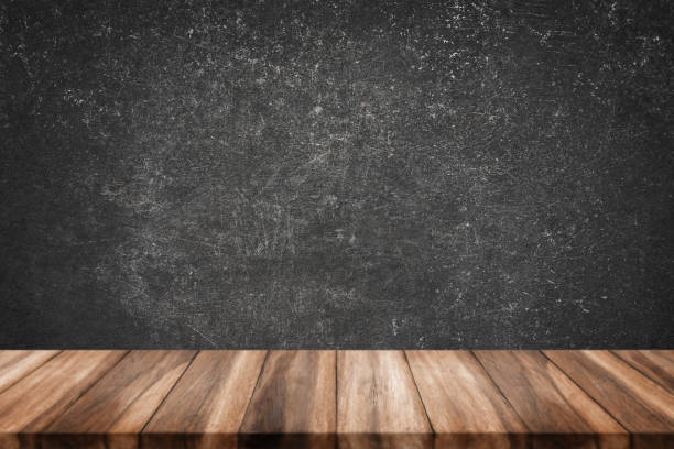 istock wood table with grunge concrete wall. 1071948592
