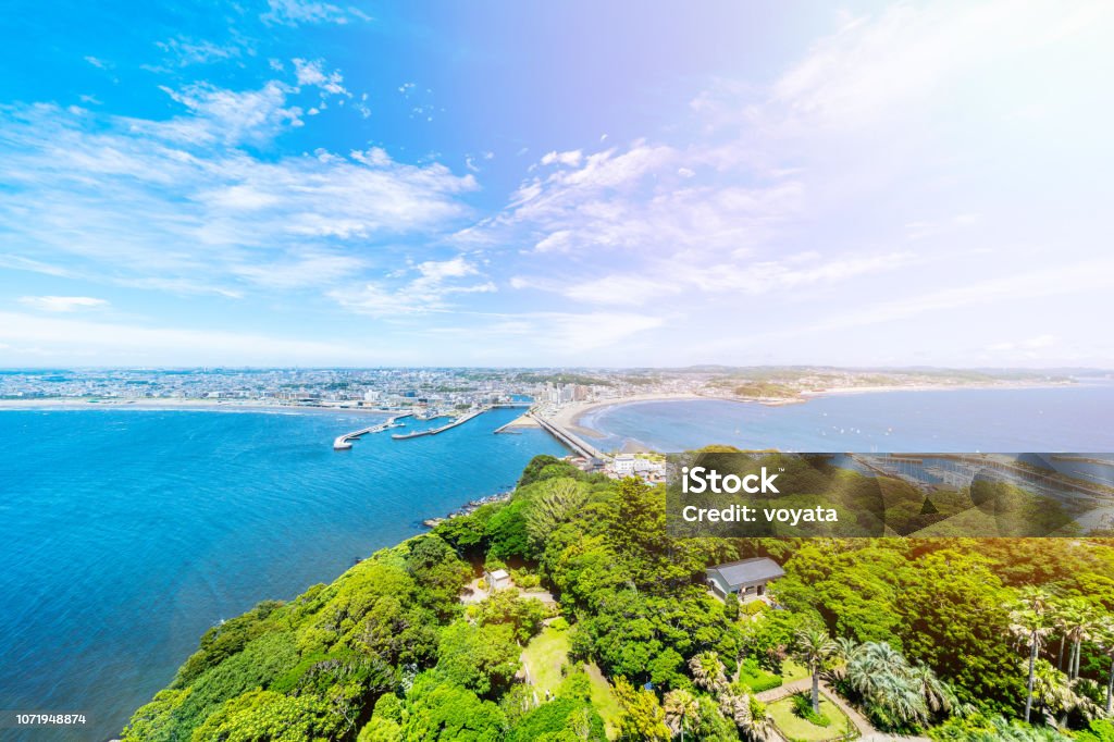 enoshima island and urban skyline aerial view Asia travel concept -  the famous travel place, enoshima island and urban skyline aerial panoramic view under dramatic blue sky and beautiful ocean in kamakura, Japan. Enoshima Island Stock Photo