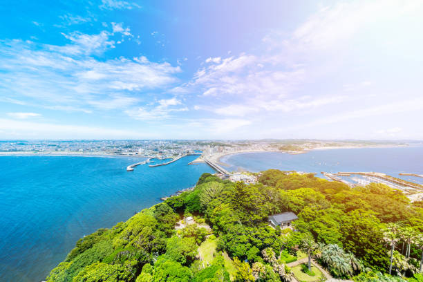 enoshima island and urban skyline aerial view Asia travel concept -  the famous travel place, enoshima island and urban skyline aerial panoramic view under dramatic blue sky and beautiful ocean in kamakura, Japan. sagami bay photos stock pictures, royalty-free photos & images