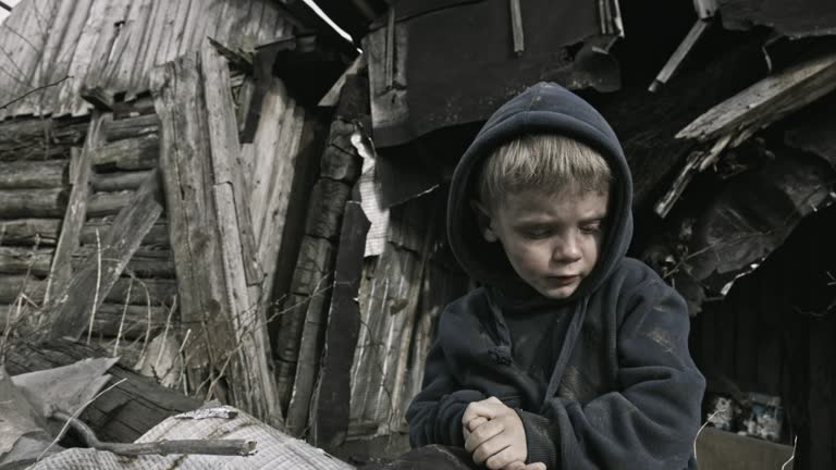 A homeless child on the ruins. Refugee.