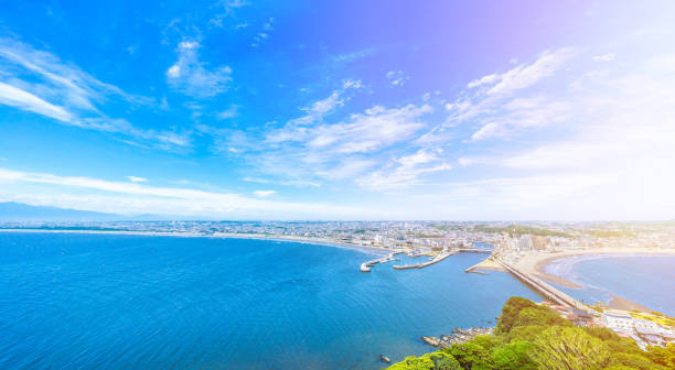 enoshima island and urban skyline aerial view Asia travel concept -  the famous travel place, enoshima island and urban skyline aerial panoramic view under dramatic blue sky and beautiful ocean in kamakura, Japan. fujisawa kanagawa photos stock pictures, royalty-free photos & images