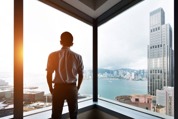 istock Businessman looking at city through office window 1071954220