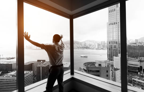 istock Businessman looking at city through office window 1071954348