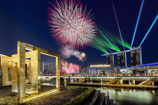national day firework at marina bay of singapore city skyline - laser firework display performance showing imagens e fotografias de stock