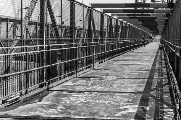 Into the Williamsburg bridge A view of Williamsburg bridge, where a man is resting seating in a bar in black and white williamsburg bridge stock pictures, royalty-free photos & images
