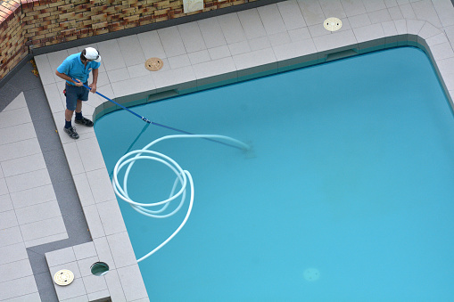 Aerial view of a pool cleaner cleaning a pool.