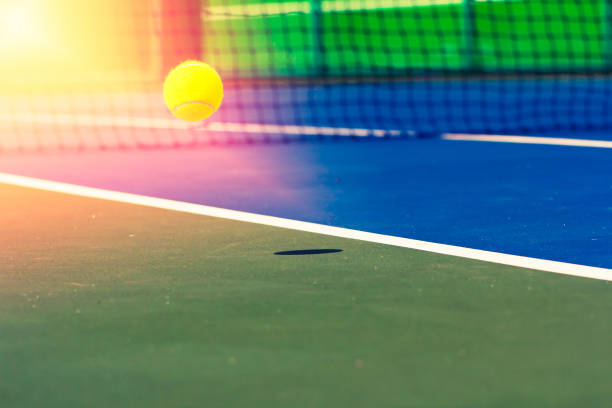 istock Tennis ball falling on the court 1071973994