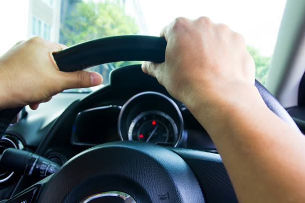 istock Hands of driver in a car 1071975414