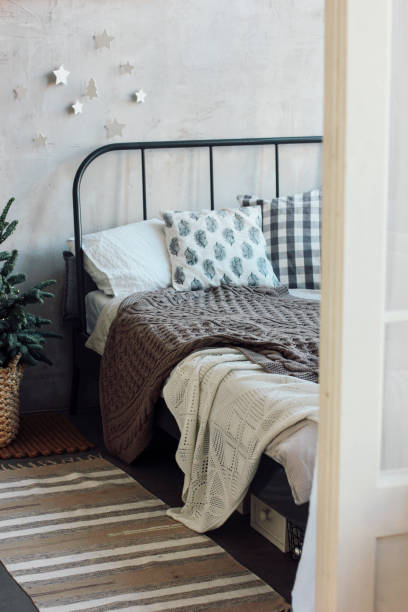 istock The old bed with pillows and knitted blanket. Minimalistic Chris 1071977324