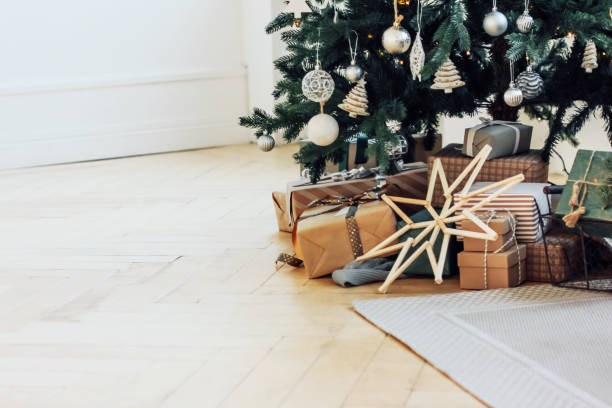 Gifts under decorated Christmas tree, minimalistic Scandinavian