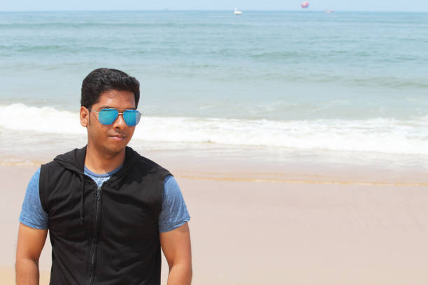 istock Handsome young man at beach on sunny morning 1071981734