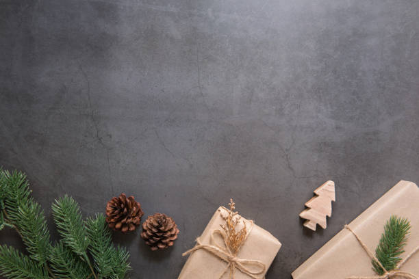 istock Christmas gift boxess pine branches on black background. Flat lay, top view 1071983596