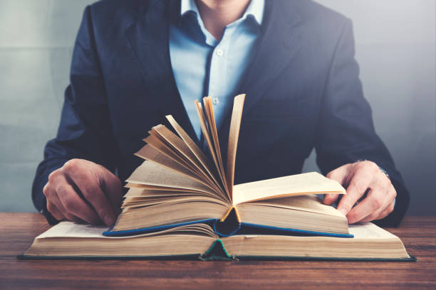 istock man hand  books on wooden table 1071985968
